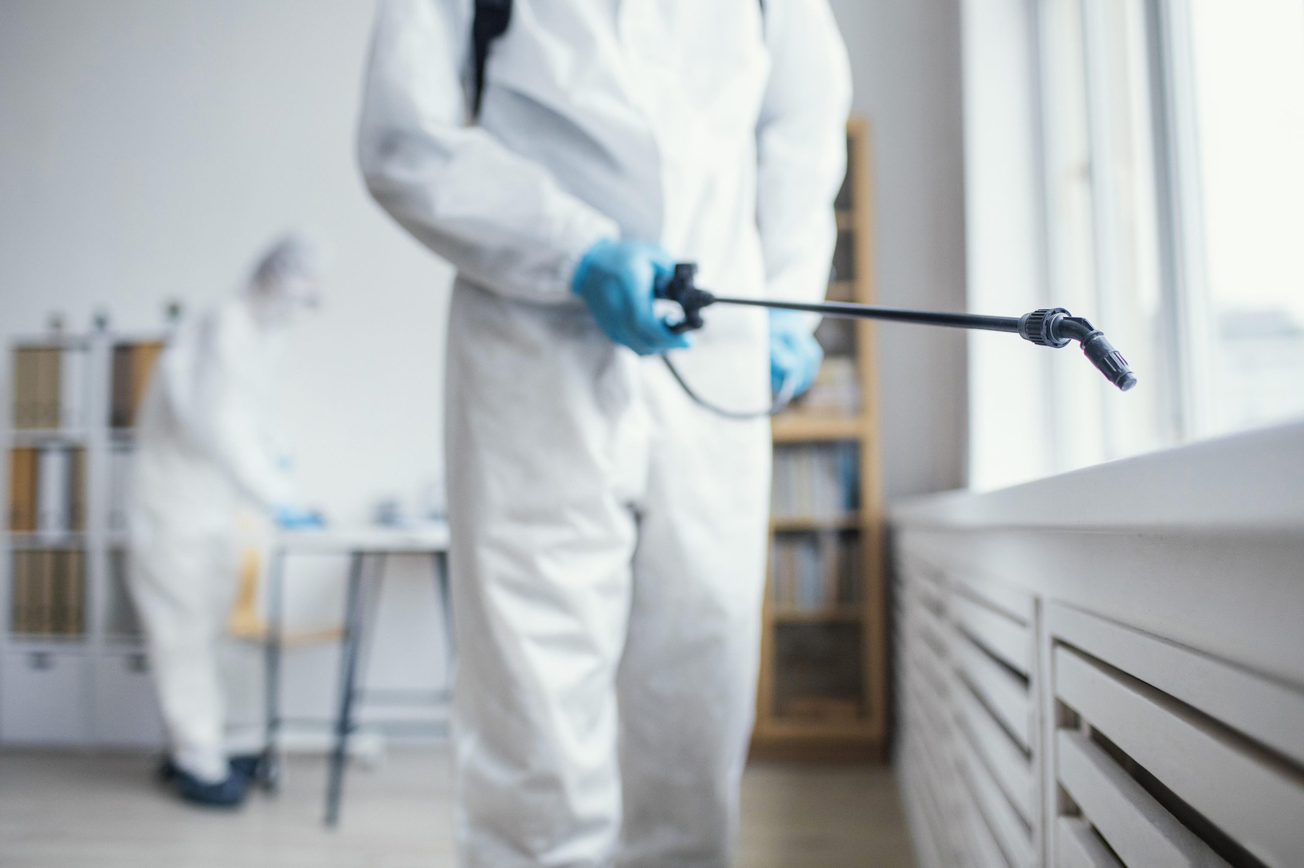 people disinfecting biohazard area